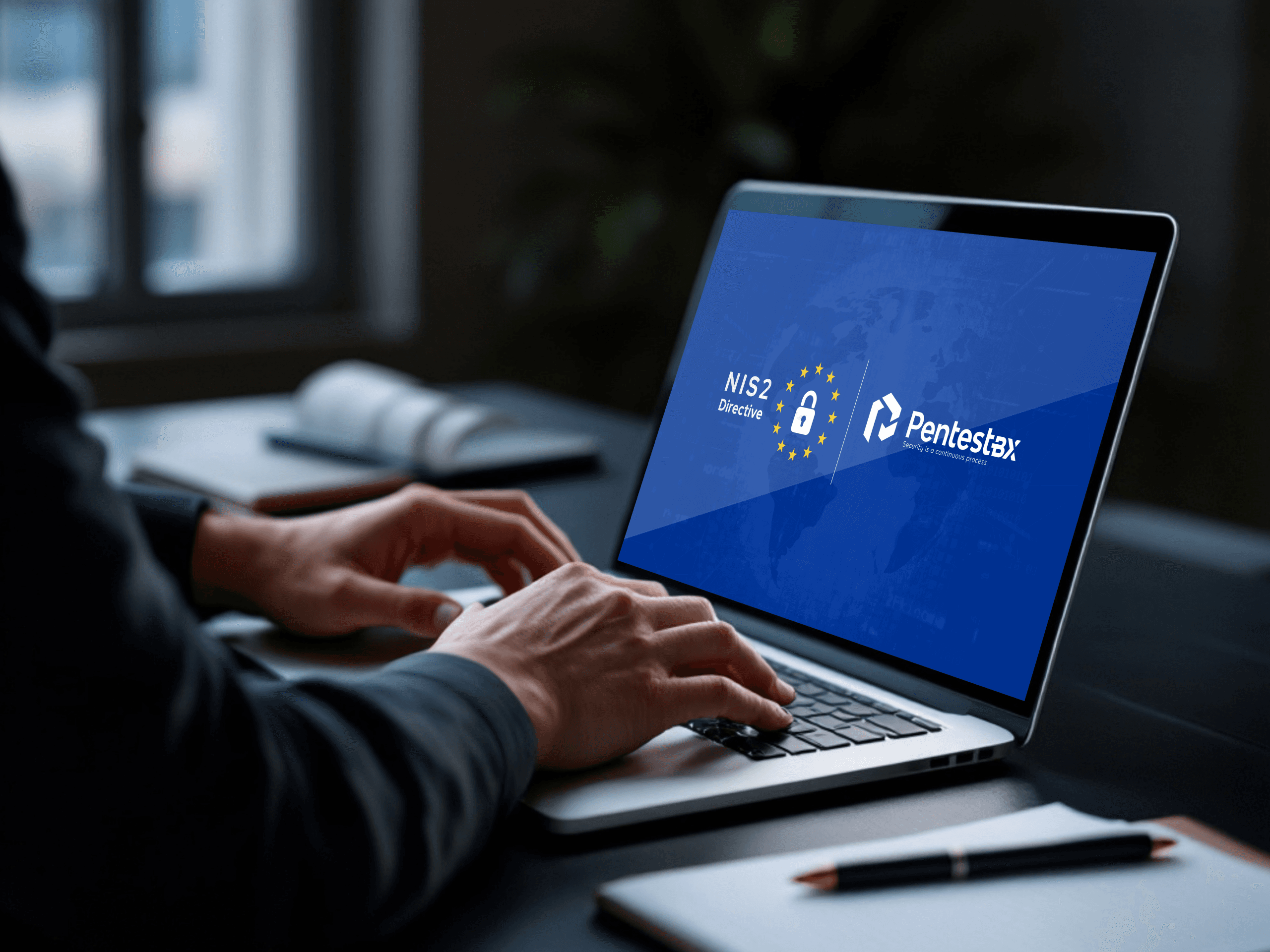 A person working on a laptop displaying the NIS2 directive and PentestBX logos